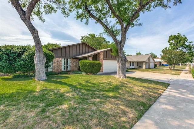 10116 Willfield Dr, Austin, TX 78753 - mid-century inspired home with board and batten siding, driveway, brick siding, an attached garage, and a front lawn