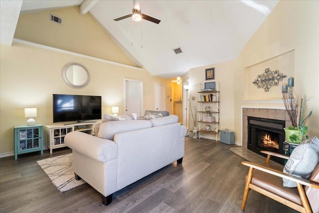 14300 Anita Marie Ln, Austin, TX 78728 - living area with high vaulted ceiling, a ceiling fan, a tiled fireplace, beam ceiling, and wood finished floors