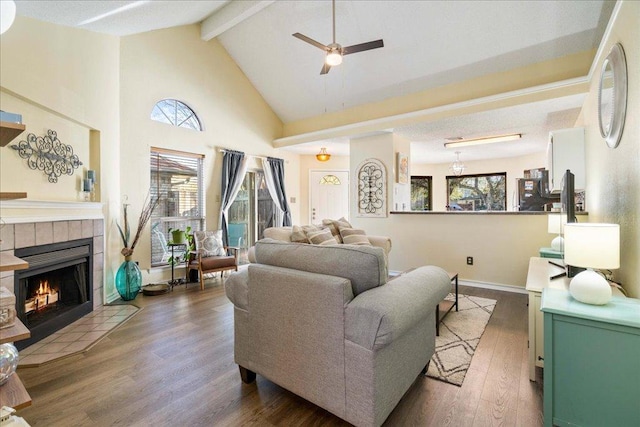14300 Anita Marie Ln, Austin, TX 78728 - living area featuring beam ceiling, ceiling fan, wood finished floors, a fireplace, and high vaulted ceiling