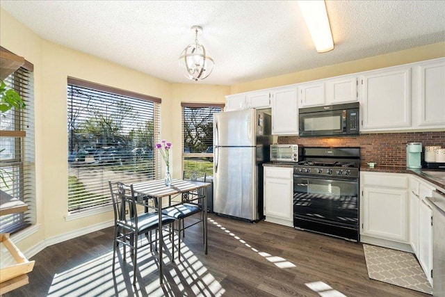 14300 Anita Marie Ln, Austin, TX 78728 - kitchen featuring black appliances, dark countertops, tasteful backsplash, a chandelier, and white cabinetry