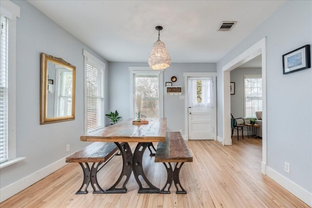 203 Ben Howell Dr, Austin, TX 78704 - dining area featuring light wood finished floors and a chandelier