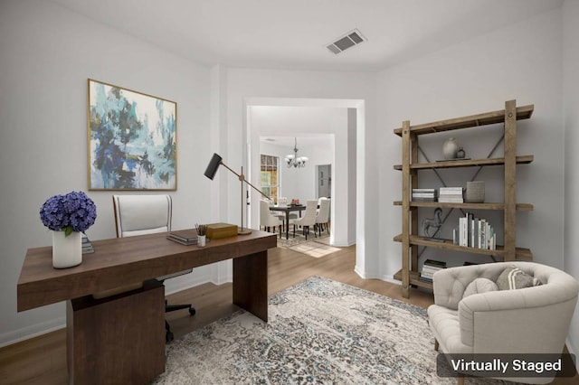 14309 Broadwinged Hawk Dr, Austin, TX 78738 - office with a chandelier, wood finished floors, and baseboards