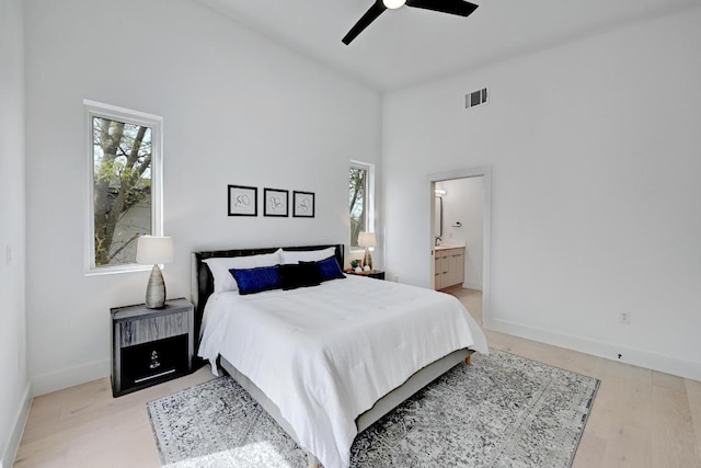 4703 Mount Vernon Dr Unit 1, Austin, TX 78745 - bedroom with a towering ceiling, light wood-type flooring, connected bathroom, and a ceiling fan