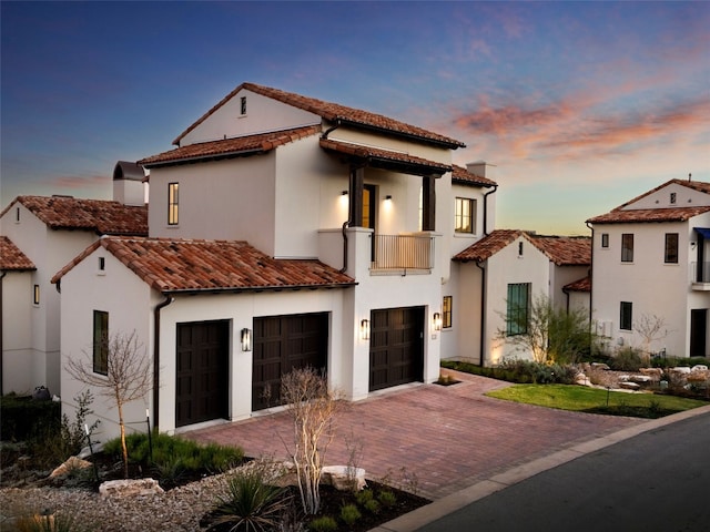 4401 Amarra Dr Unit 14, Austin, TX 78735 - mediterranean / spanish home with a balcony, an attached garage, stucco siding, decorative driveway, and a tiled roof