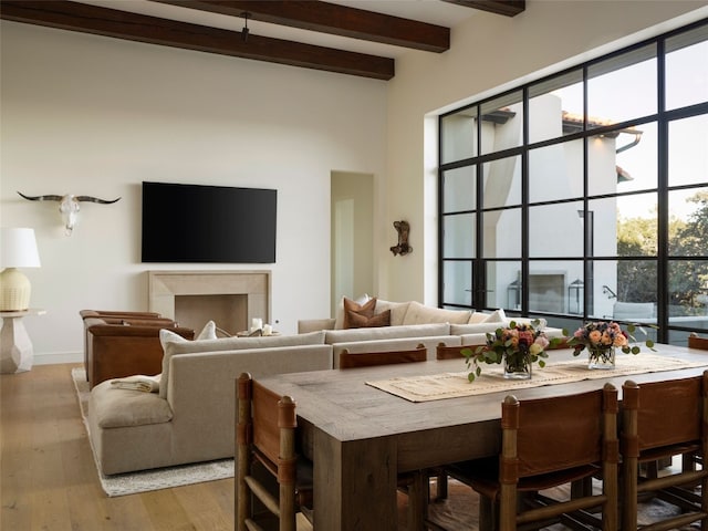 4401 Amarra Dr Unit 14, Austin, TX 78735 - dining space with beamed ceiling, light wood finished floors, and a towering ceiling