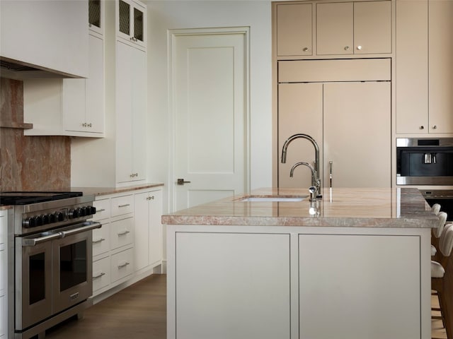 4401 Amarra Dr Unit 14, Austin, TX 78735 - kitchen with double oven range, a sink, light stone counters, wall oven, and dark wood-type flooring