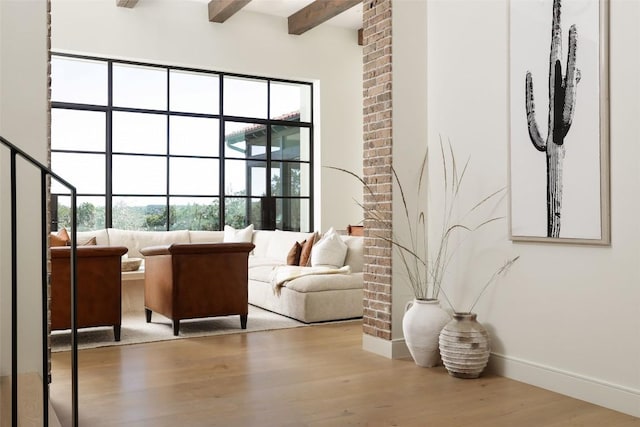 4401 Amarra Dr Unit 14, Austin, TX 78735 - living room featuring healthy amount of natural light, wood finished floors, and beamed ceiling