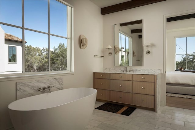 4401 Amarra Dr Unit 14, Austin, TX 78735 - ensuite bathroom featuring a freestanding bath, vanity, plenty of natural light, and marble finish flooring