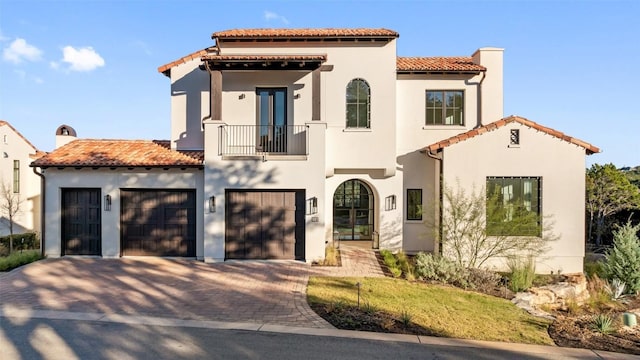 4401 Amarra Dr Unit 14, Austin, TX 78735 - mediterranean / spanish-style home with a balcony, driveway, a tile roof, and stucco siding