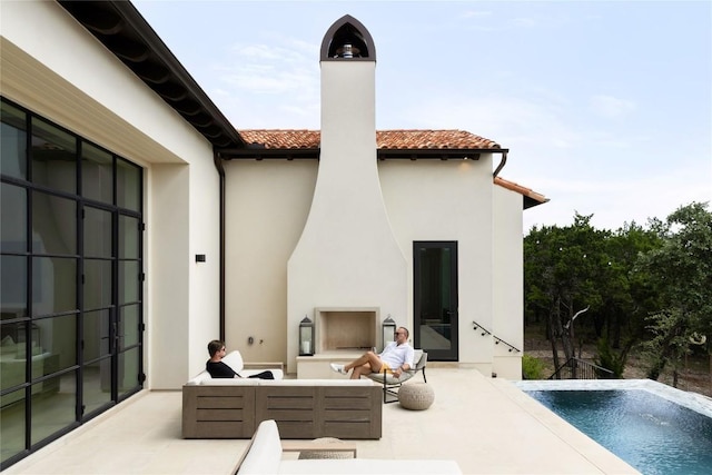 4401 Amarra Dr Unit 14, Austin, TX 78735 - back of property featuring a chimney, stucco siding, outdoor lounge area, a patio, and a tiled roof