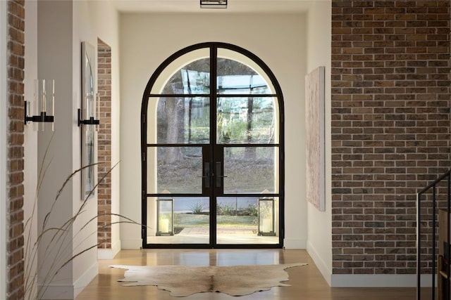 4401 Amarra Dr Unit 14, Austin, TX 78735 - doorway to outside featuring french doors, wood finished floors, and brick wall