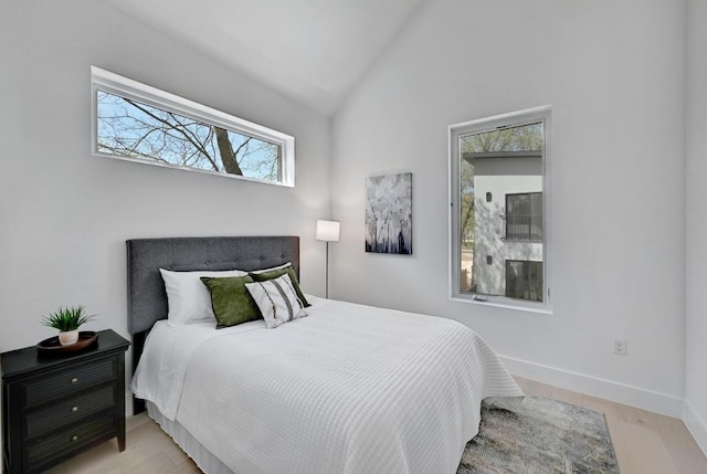 4703 Mount Vernon Dr Unit 2, Austin, TX 78745 - bedroom with vaulted ceiling, baseboards, and light wood-type flooring