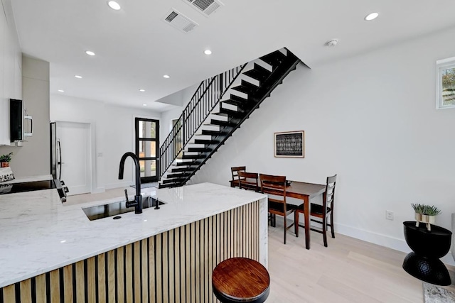 4703 Mount Vernon Dr Unit 2, Austin, TX 78745 - kitchen featuring black electric range oven, a sink, healthy amount of natural light, light stone counters, and recessed lighting