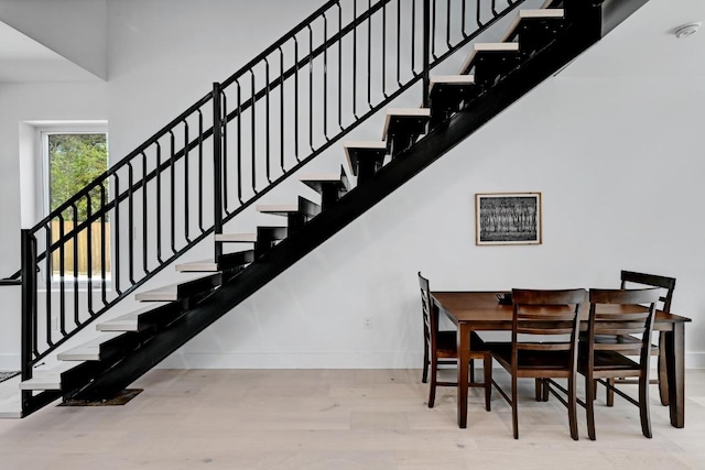 4703 Mount Vernon Dr Unit 2, Austin, TX 78745 - dining space with wood finished floors, baseboards, stairs, and a high ceiling