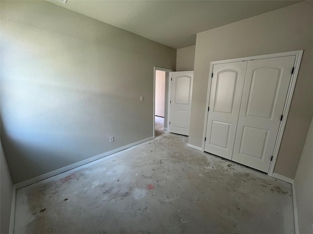 2456 Walking Y Rd, Georgetown, TX 78633 - unfurnished bedroom featuring unfinished concrete floors, baseboards, and a closet
