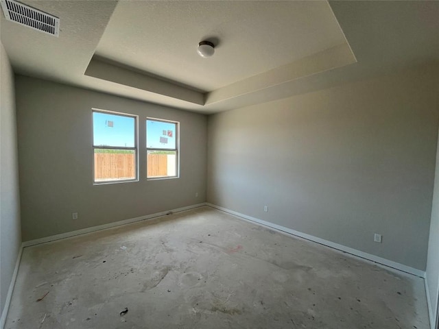 2456 Walking Y Rd, Georgetown, TX 78633 - unfurnished room with a tray ceiling, baseboards, and unfinished concrete flooring