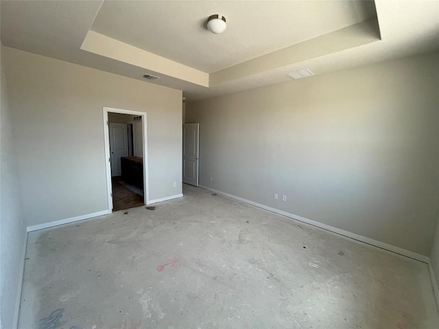 2456 Walking Y Rd, Georgetown, TX 78633 - unfurnished bedroom featuring a raised ceiling, unfinished concrete flooring, and baseboards
