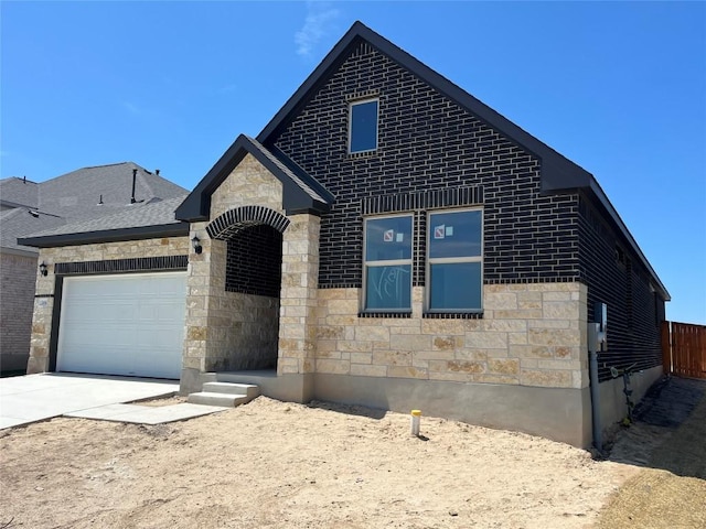 2456 Walking Y Rd, Georgetown, TX 78633 - view of front facade with stone siding, a garage, and concrete driveway