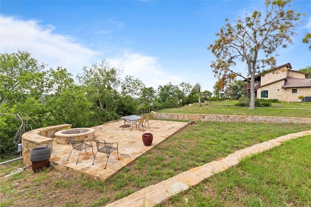 25421 Pedernales Point Dr, Spicewood, TX 78669 - view of grassy yard with an outdoor fire pit and a patio