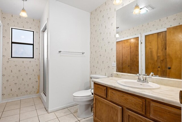 2301 Lawnmont Ave Apt 1, Austin, TX 78756 - bathroom featuring wallpapered walls, vanity, tile patterned flooring, and a shower stall