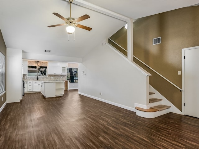 716 Shiny Rock Dr, Austin, TX 78748 - unfurnished living room with vaulted ceiling, dark wood-type flooring, ceiling fan, stairs, and a sink