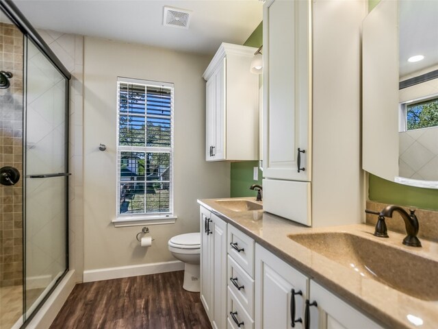 716 Shiny Rock Dr, Austin, TX 78748 - full bath with toilet, a stall shower, double vanity, wood finished floors, and baseboards