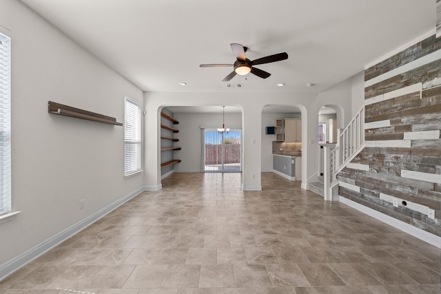 12923 Dwight Eisenhower St, Manor, TX 78653 - unfurnished living room with ceiling fan, arched walkways, stairway, recessed lighting, and baseboards