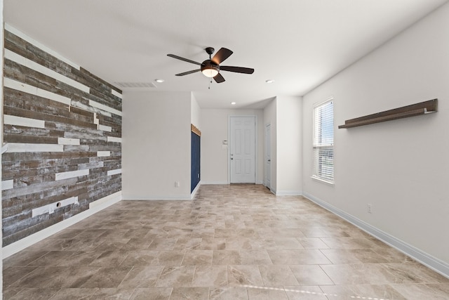 12923 Dwight Eisenhower St, Manor, TX 78653 - empty room with a ceiling fan, recessed lighting, baseboards, and wood walls