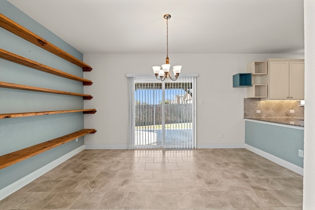 12923 Dwight Eisenhower St, Manor, TX 78653 - unfurnished dining area featuring a chandelier and baseboards