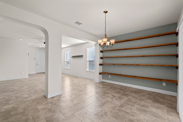 12923 Dwight Eisenhower St, Manor, TX 78653 - spare room featuring a chandelier, ceiling fan, baseboards, and arched walkways