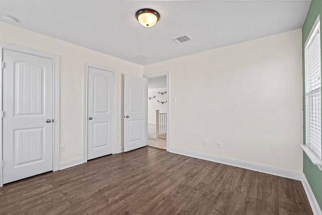 12923 Dwight Eisenhower St, Manor, TX 78653 - unfurnished bedroom with dark wood finished floors and baseboards