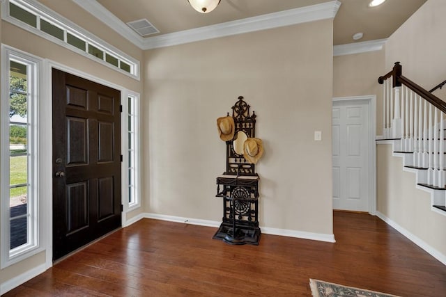 foyer with stairs, crown molding, wood finished floors, baseboards, and visible vents