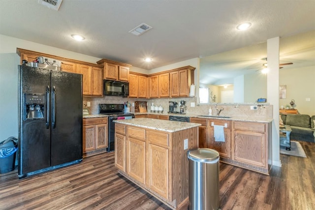 6806 Ambrose Cir, Temple, TX 76502 - kitchen with tasteful backsplash, visible vents, dark wood-style floors, black appliances, and a sink