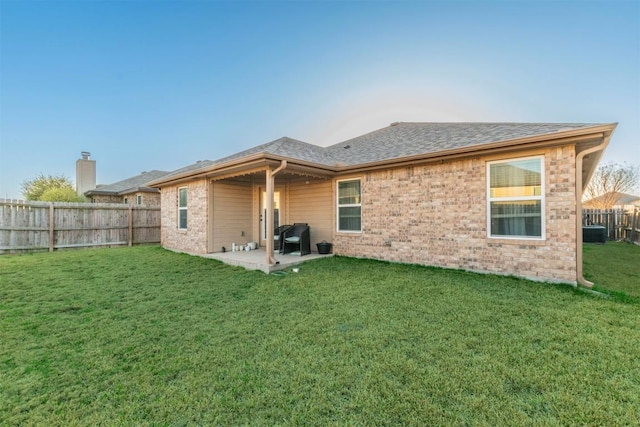 6806 Ambrose Cir, Temple, TX 76502 - back of house with brick siding, a patio area, a fenced backyard, and a lawn