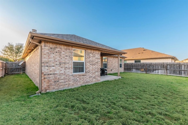 6806 Ambrose Cir, Temple, TX 76502 - back of house featuring a patio, a lawn, brick siding, and a fenced backyard