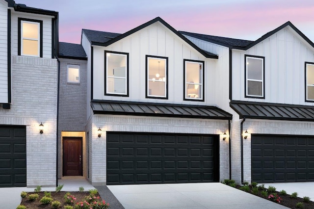 1955 Settlers Glen Dr Unit 4403, Round Rock, TX 78665 - view of front facade with a standing seam roof, an attached garage, and brick siding