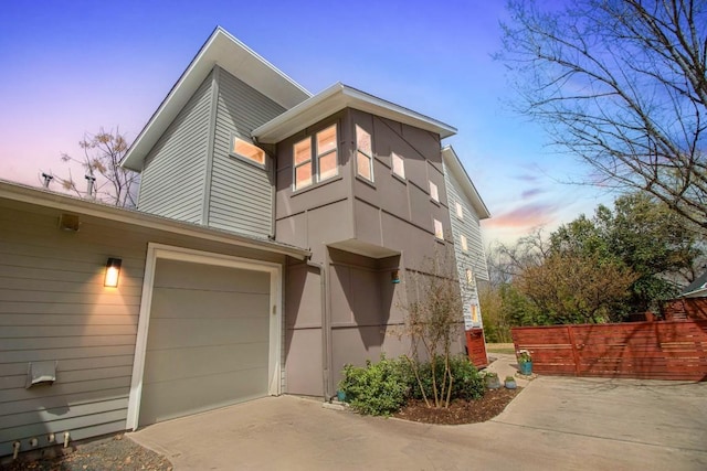 402 Irma Dr Unit B, Austin, TX 78752 - view of side of property with driveway, a garage, and stucco siding