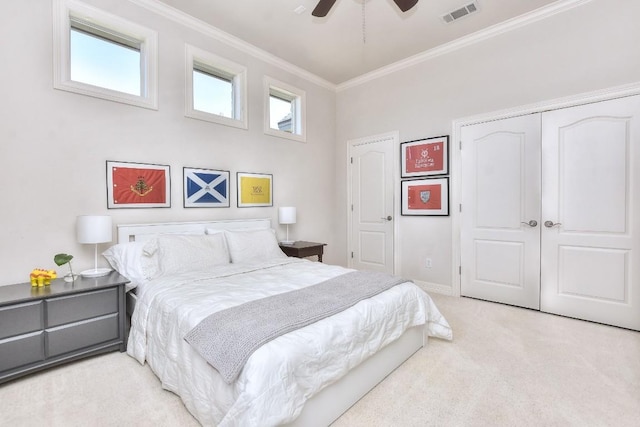 carpeted bedroom featuring crown molding, visible vents, ceiling fan, baseboards, and a closet