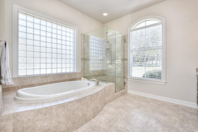 bathroom with a garden tub, a stall shower, tile patterned floors, and plenty of natural light