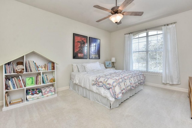 carpeted bedroom featuring a ceiling fan and baseboards