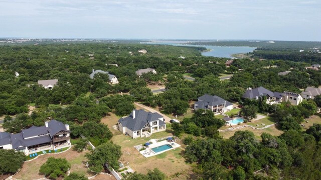bird's eye view with a wooded view, a residential view, and a water view