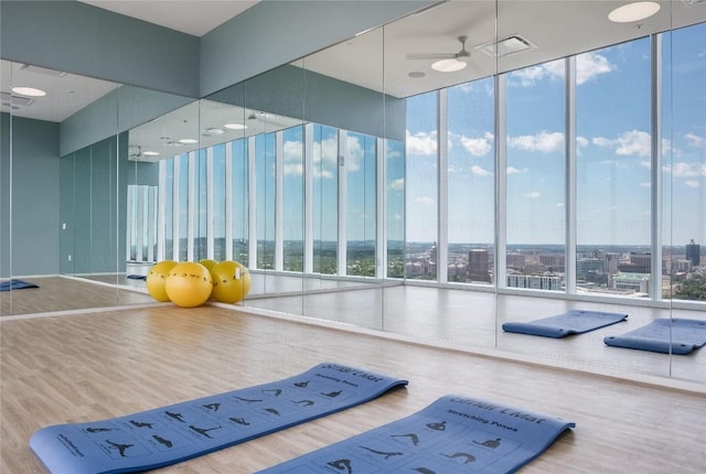 301 W Ave Unit 1301, Austin, TX 78701 - gym featuring a ceiling fan, expansive windows, a high ceiling, and wood finished floors