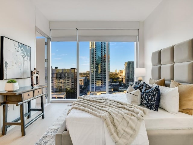 301 W Ave Unit 1301, Austin, TX 78701 - bedroom with a city view, multiple windows, wood finished floors, and access to outside