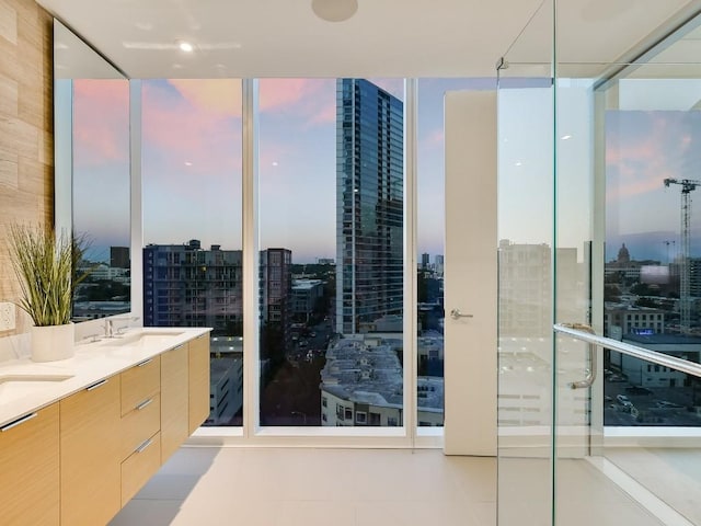 301 W Ave Unit 1301, Austin, TX 78701 - bathroom featuring expansive windows, a view of city, double vanity, and tile patterned floors