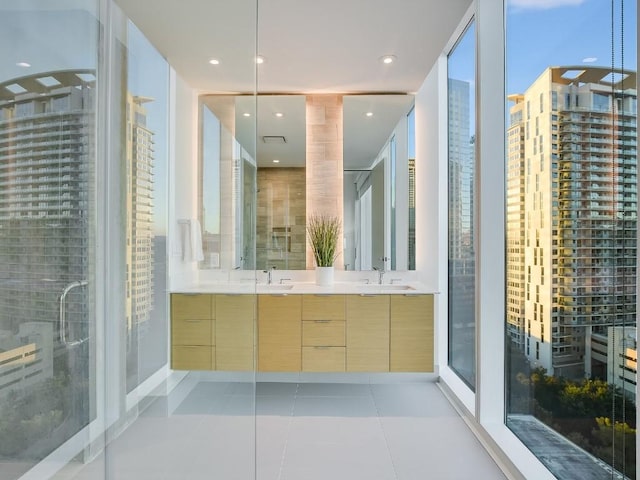 301 W Ave Unit 1301, Austin, TX 78701 - full bathroom with double vanity, tile patterned floors, a shower stall, and recessed lighting