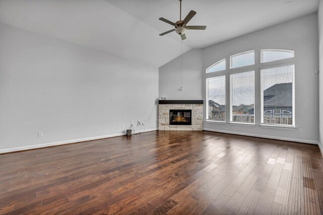 252 Sabino Dr, Buda, TX 78610 - unfurnished living room with ceiling fan, a fireplace, dark wood-style flooring, high vaulted ceiling, and baseboards