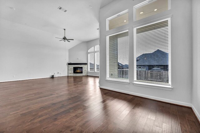 252 Sabino Dr, Buda, TX 78610 - unfurnished living room with a ceiling fan, a fireplace, wood finished floors, baseboards, and lofted ceiling