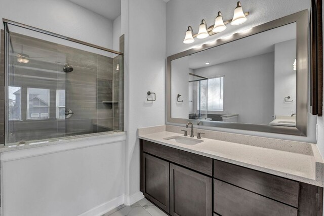 252 Sabino Dr, Buda, TX 78610 - bathroom featuring a stall shower, vanity, marble look tiles, and baseboards