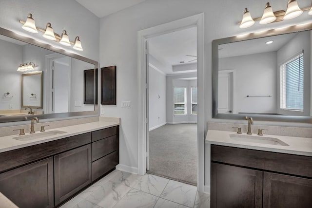 252 Sabino Dr, Buda, TX 78610 - full bath with two vanities, marble finish flooring, and baseboards