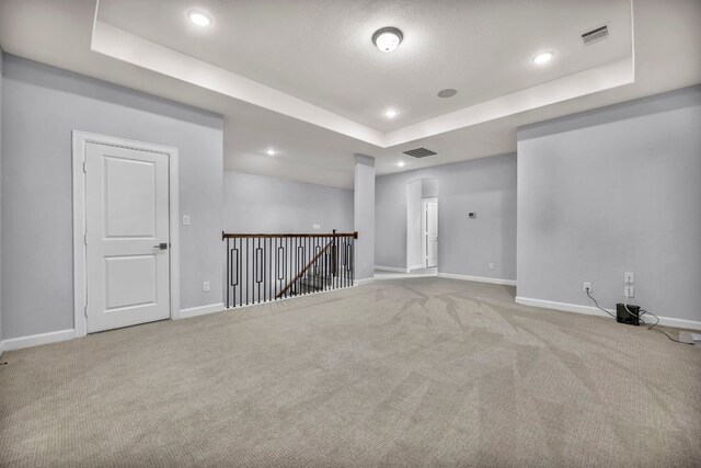 252 Sabino Dr, Buda, TX 78610 - carpeted spare room featuring a tray ceiling, baseboards, and recessed lighting